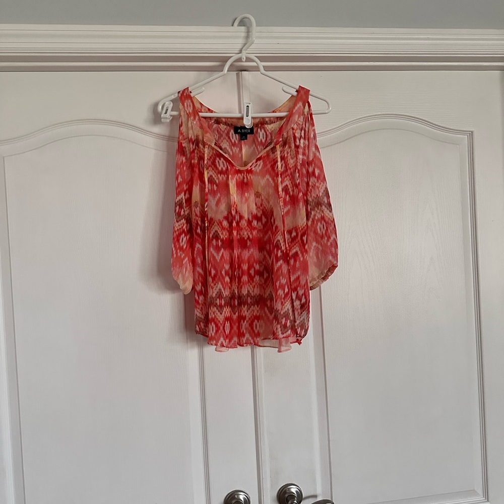 Cold shoulder top. A variety of colors from the orange family.